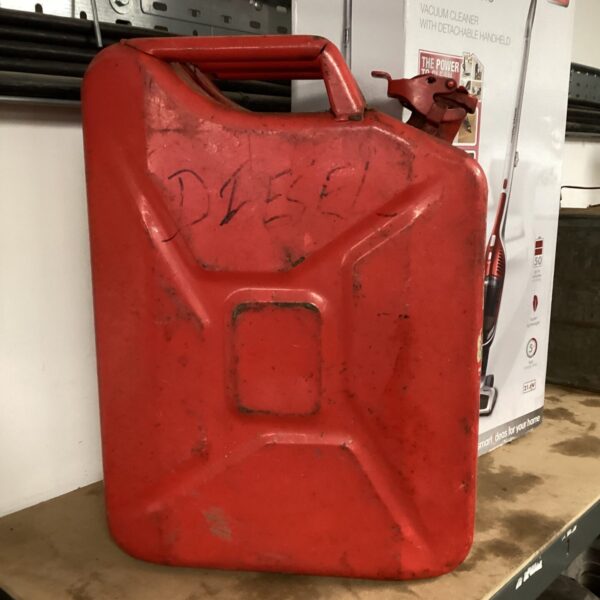 Red 20L metal jerry can showing signs of wear.