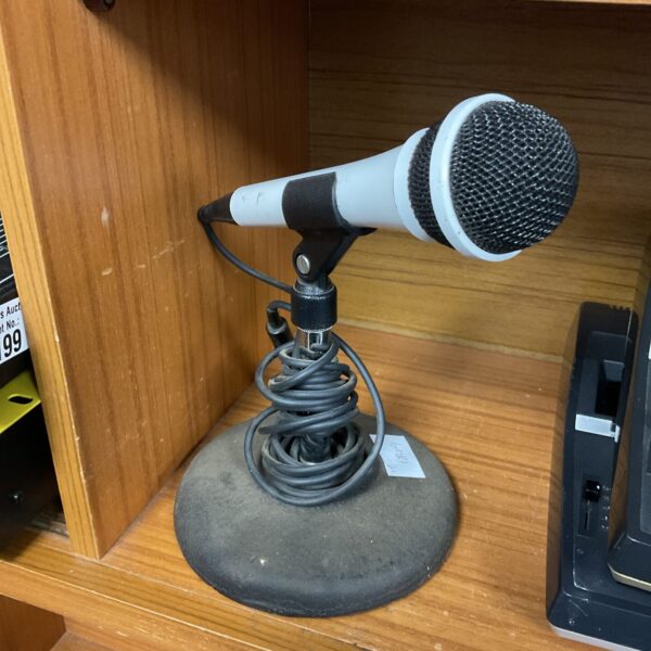 Vintage microphone with stand, classic retro audio equipment.