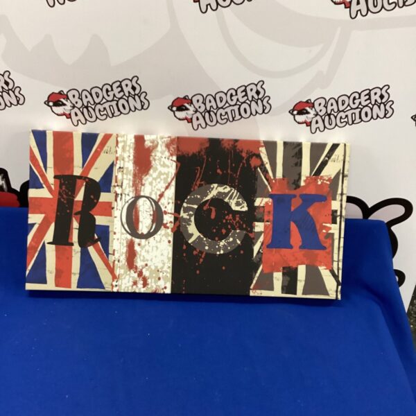 Distressed Union Jack rock wall hanging for home decor.