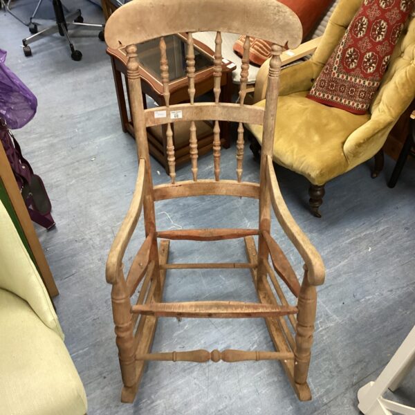 Antique wooden rocking chair awaiting restoration project.