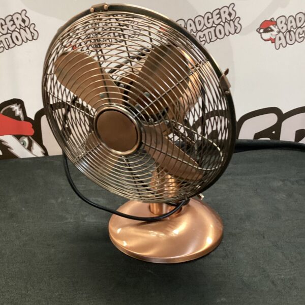 Stylish rose gold desk fan with metal cage.
