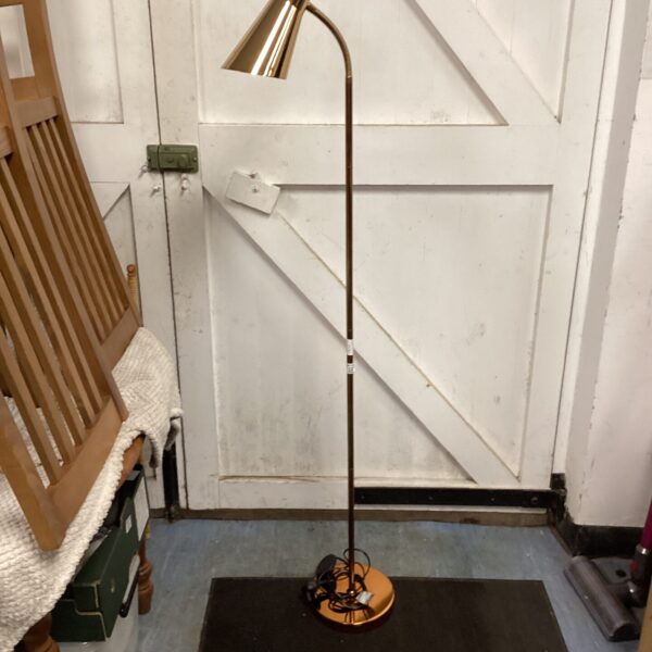 Elegant rose gold floor lamp with adjustable shade.
