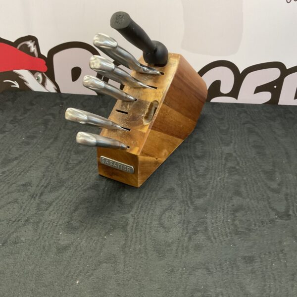 Wooden Sabatier knife block with stainless steel knives displayed.