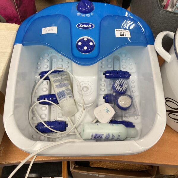 Electric Scholl foot massager with scrub attachment for relaxing foot care.