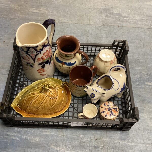 Mixed pottery lot featuring a vintage cow milk jug.