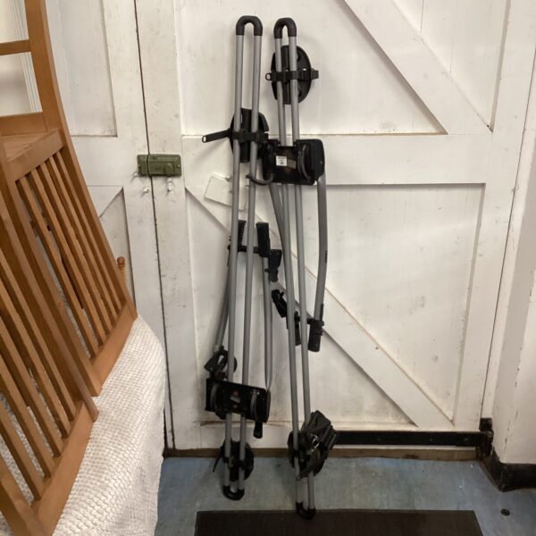 Thule car roof bike racks set for secure bicycle transport.