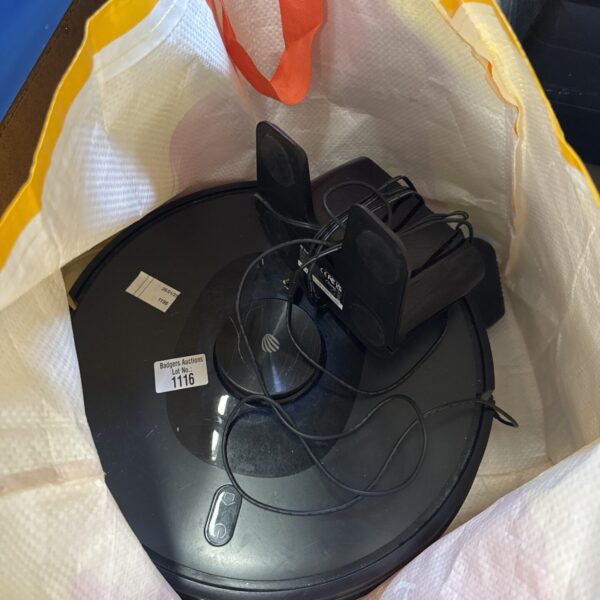 Shellbot robotic vacuum cleaner in grey, vintage home appliance.