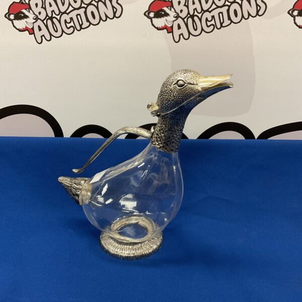 Vintage silver duck decanter with glass body and silver plate details.