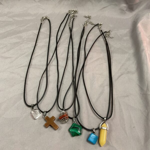 Lot of six polished stone pendant necklaces with varied colours.