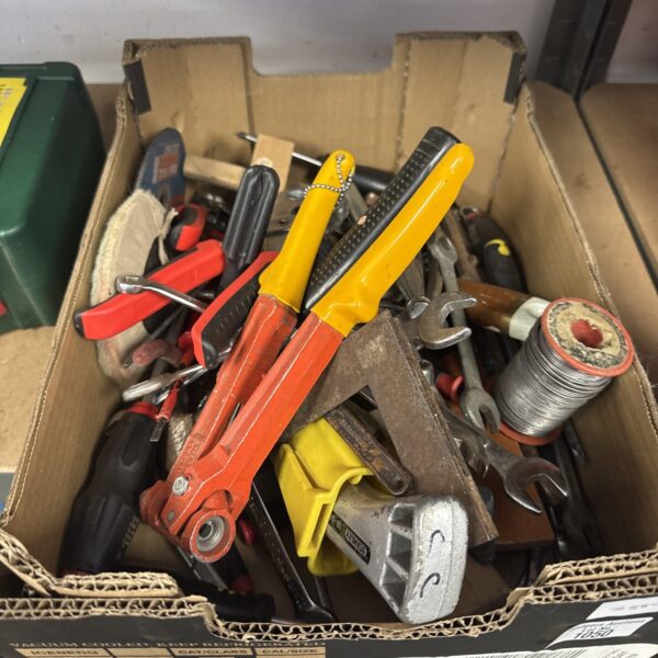 Vintage hand tools and hardware in a wooden crate.