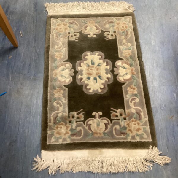 Vintage floral rug with patterned design, approximately 3x2 feet.