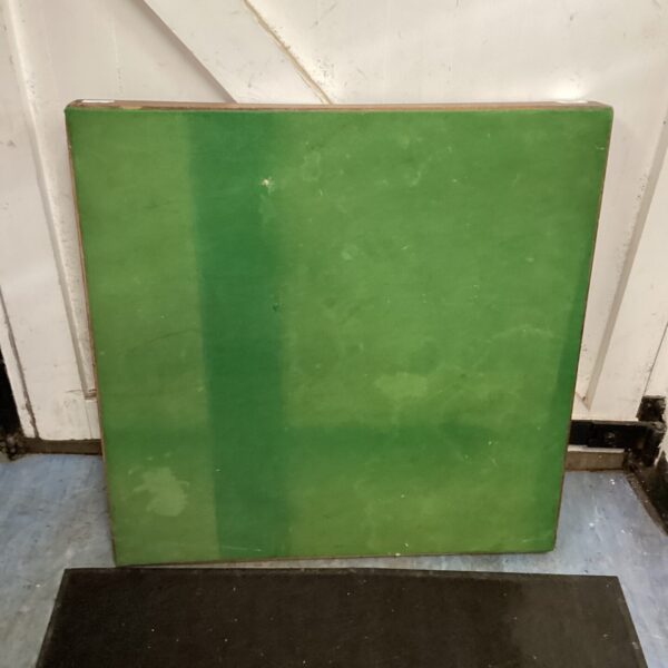 Vintage square folding card table with green laminate top.