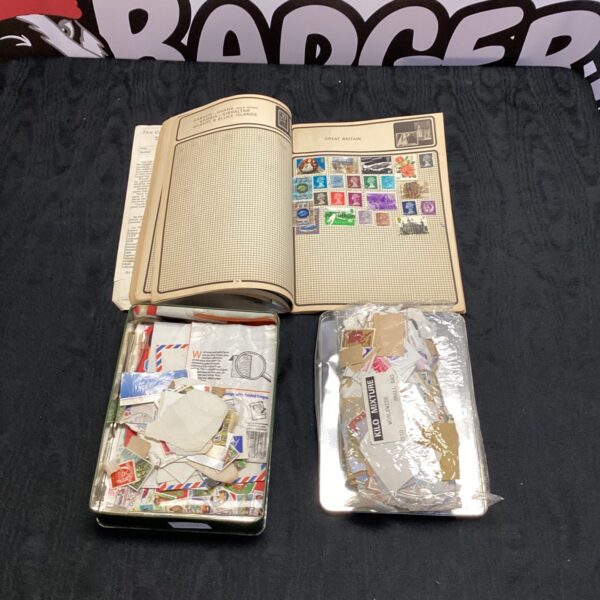 Vintage stamp collection within a book, British stamps visible.