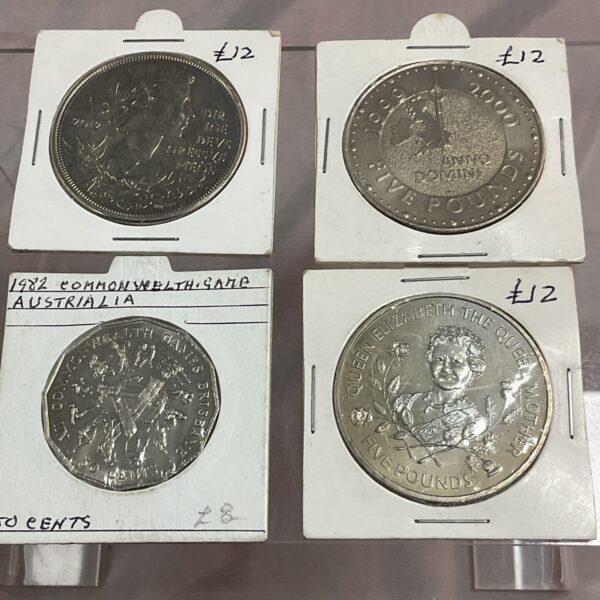 Commonwealth coin collection featuring £5 coins and Australian currency.