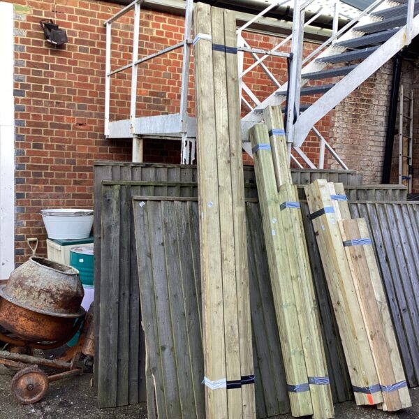 Three bundles of timber in a garden setting.