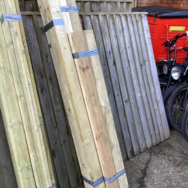 Strapped bundles of timber planks for DIY projects.
