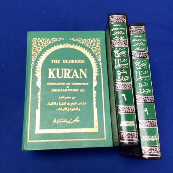 Vintage lot of three green Quran books with gold detailing.