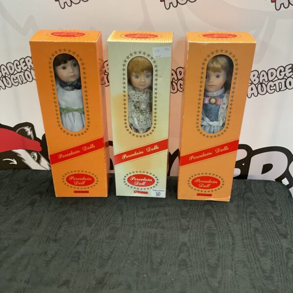 Vintage porcelain doll lot of three, detailed craftsmanship.