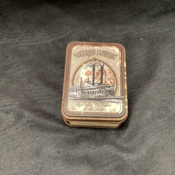 Vintage Southern Comfort tin with steamboat illustration.