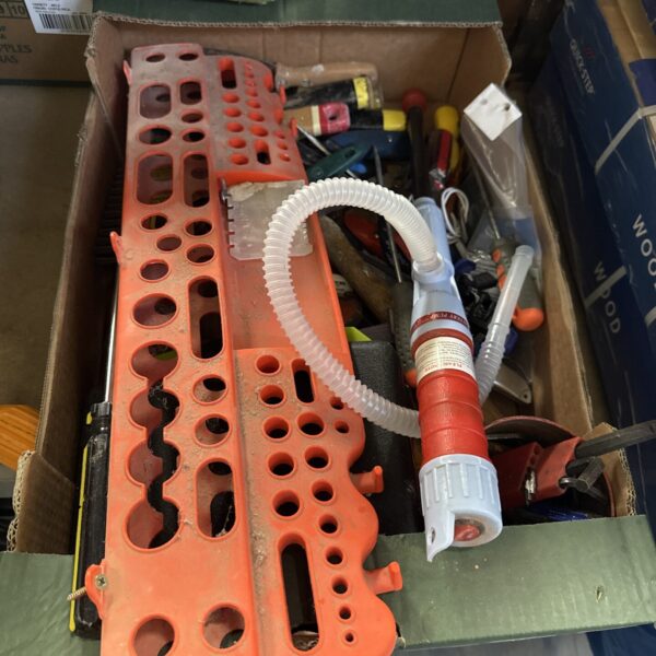 Battery powered fluid pump in a tray of shed clearance items.