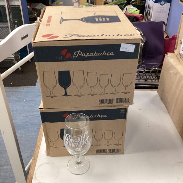 Stack of twenty-four Pasabahce pint glasses in a cardboard box.