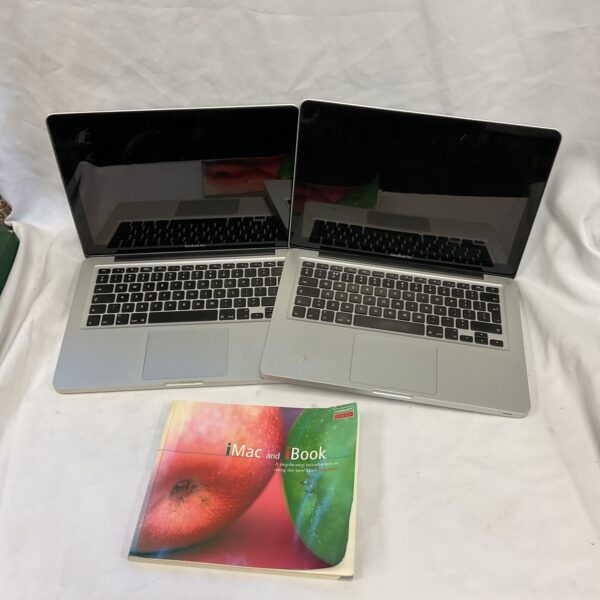 Pair of silver Apple Macbook Pro laptops for parts or restoration.