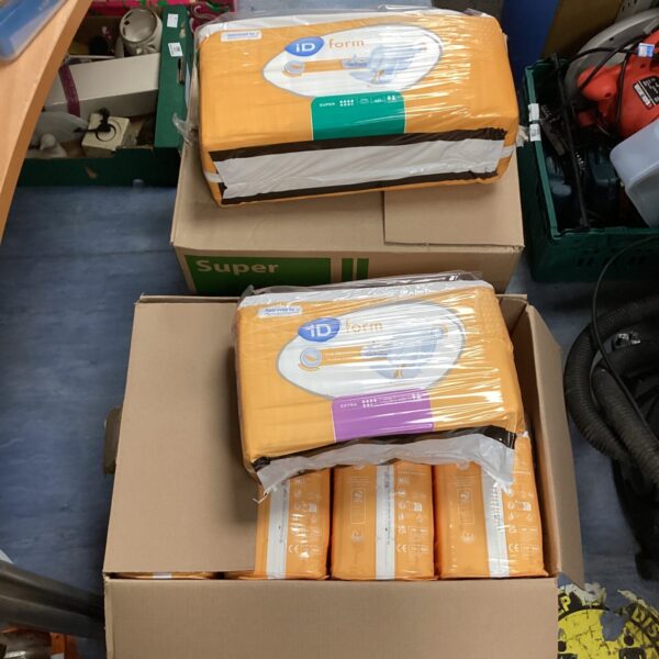 Two boxes of iD form adult nappies, size Extra and Super.