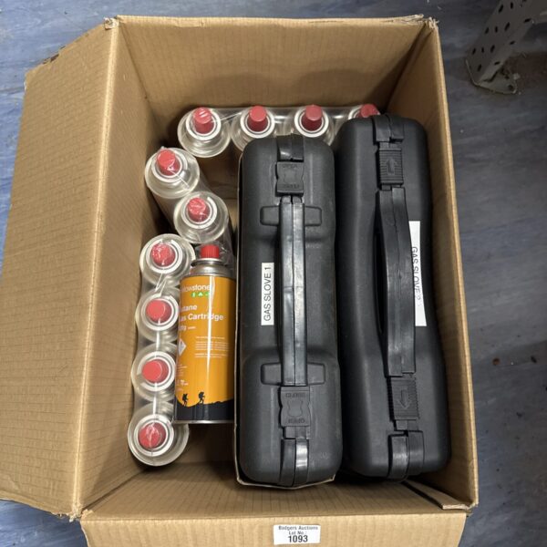 Camping gas stoves and butane canisters for outdoor cooking.