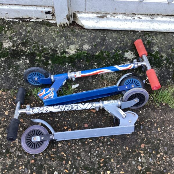 Blue vintage folding kids scooter, retro outdoor toy.