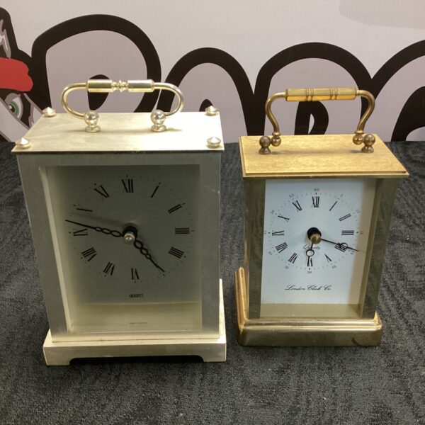 Vintage brass mantle clock with white dial and Roman numerals.
