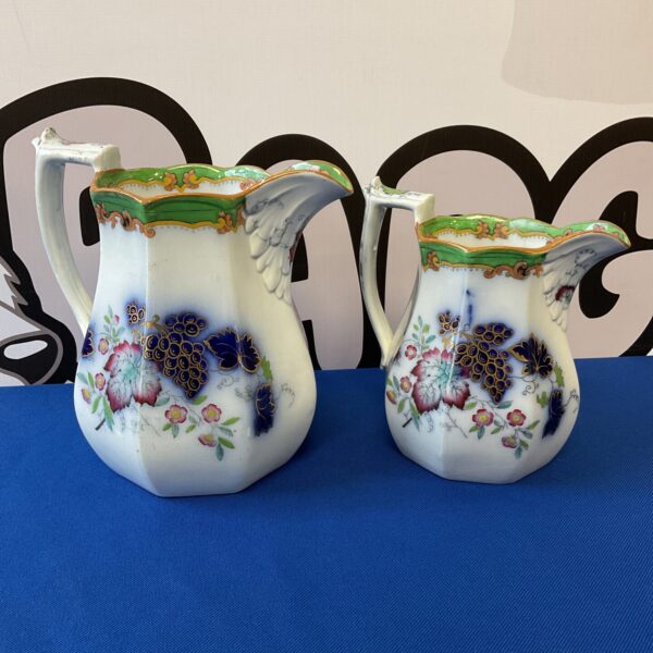 Antique 19th-century grape pattern jugs, a charming collectible pair.