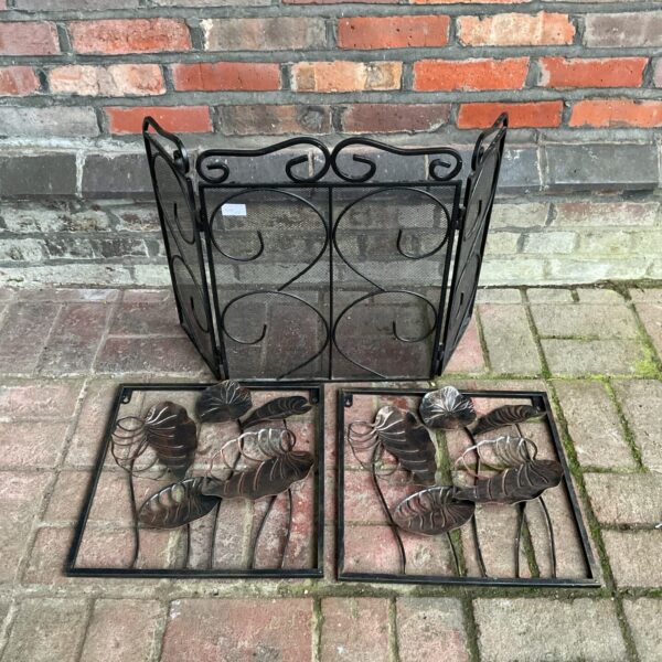 Vintage metal leaf firescreen panels for fireplace safety and decor.