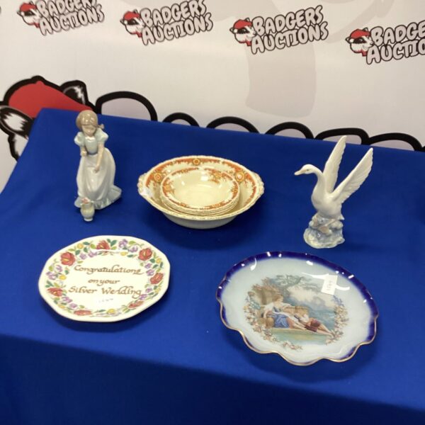 Nao figures and vintage Grindley Pottery bowls on display.