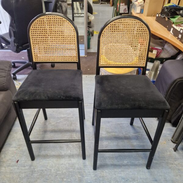 Pair of vintage rattan stools with woven seats.