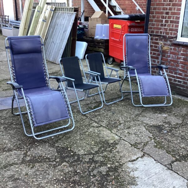 Set of garden loungers and folding chairs for outdoor use.