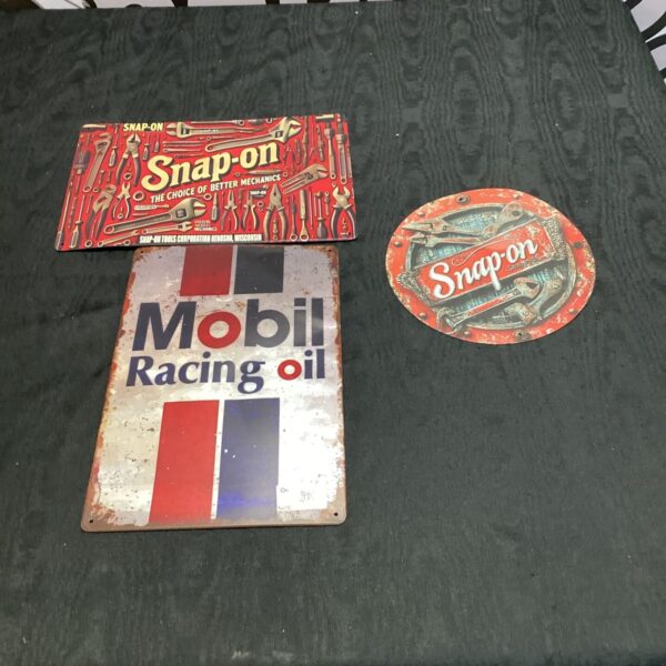 Vintage Snap On and Mobil oil tool signs for garage decor.