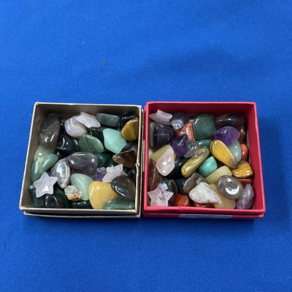 Two trays filled with colourful semi precious stones for collection.