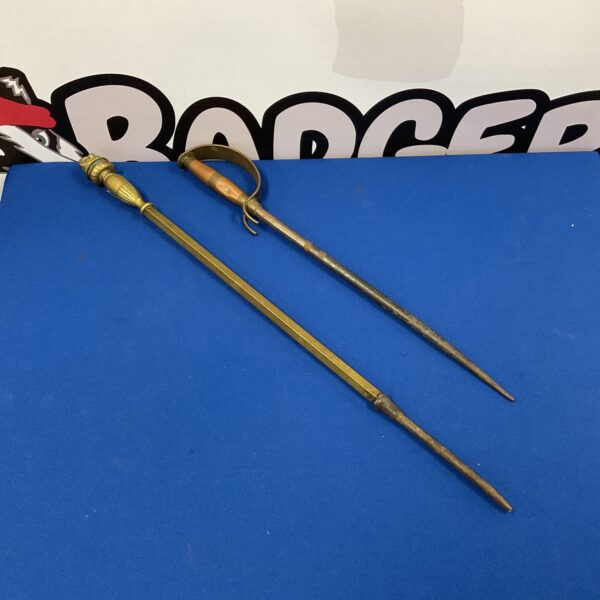 Antique Victorian fireplace pokers made of brass and copper.