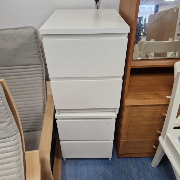 Pair of white bedside cabinets for bedroom storage.