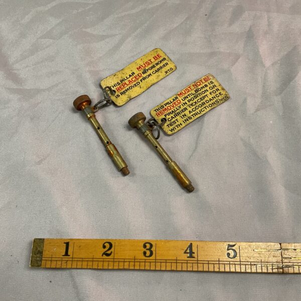 Two Ww2 bomb retaining pins with tags