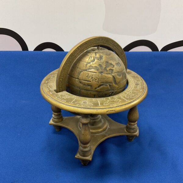 Antique Victorian brass zodiac globe on a tripod base.