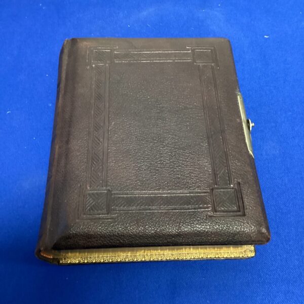 Dark brown Victorian photo album with embossed leather cover.