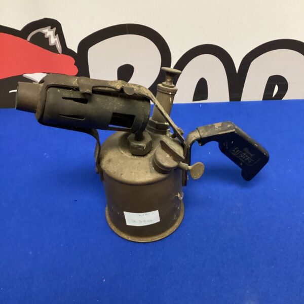 Vintage propane blow torch with brass body and dark handle.