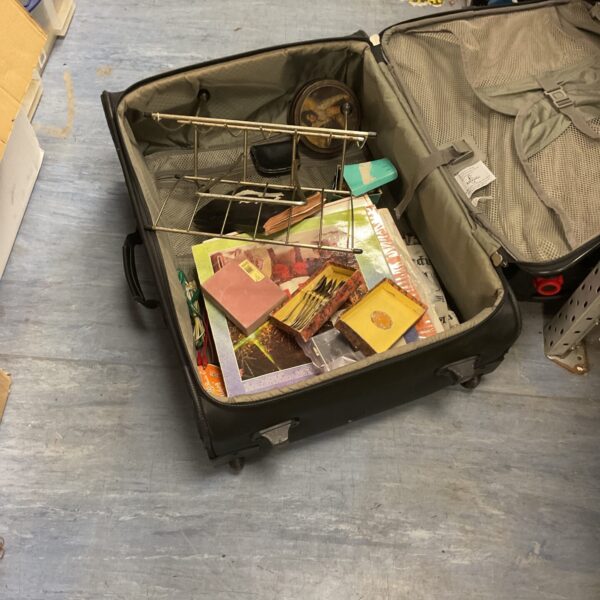 Vintage brown suitcase with contents, ideal for collectors.