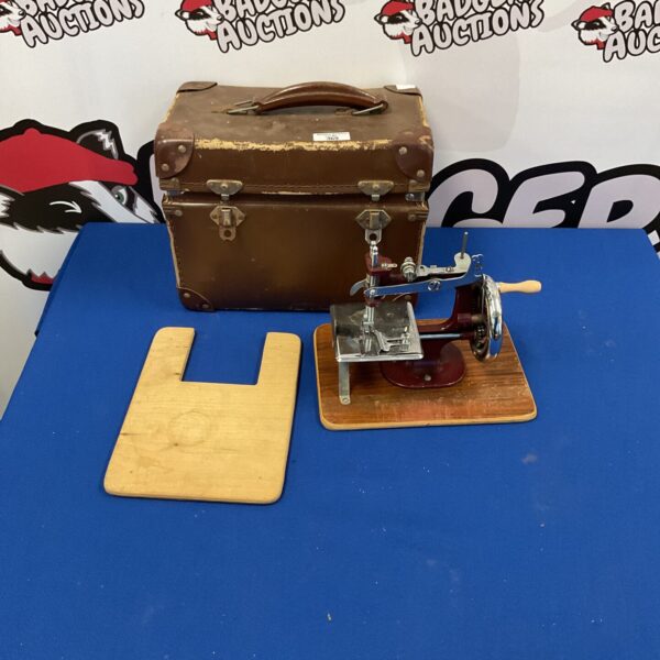 Vintage child's sewing machine in wooden case