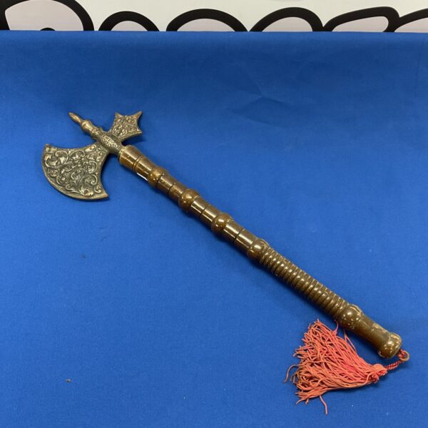 Vintage English wall hanging axe with detailed heraldic head.