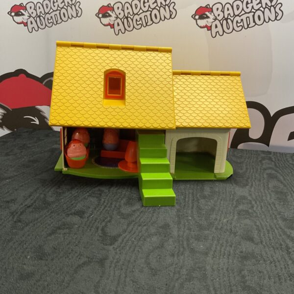 Vintage Fisher Price Weebles house with yellow roof.