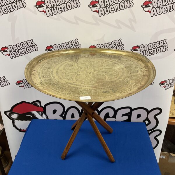 Vintage Indian brass table with embossed floral design.