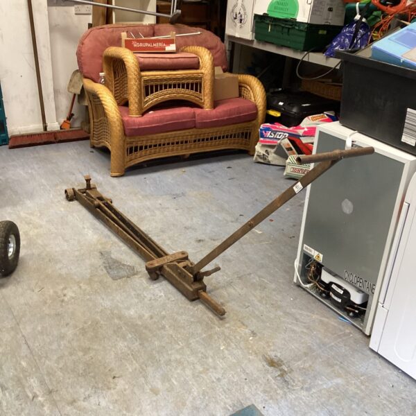 Vintage trolley jack in a garage setting.