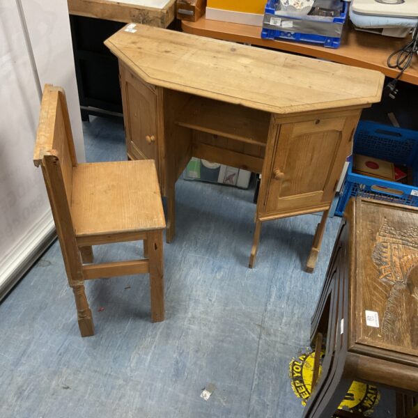 Vintage pine hideaway desk with a curved front and single drawer.